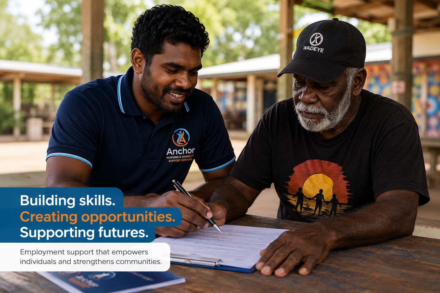 An Anchor NDSS employment support worker helping a participant complete paperwork at an outdoor table in a remote Northern Territory community, with overlaid text reading: Building skills. Creating opportunities. Supporting futures. Employment support that empowers individuals and strengthens communities.